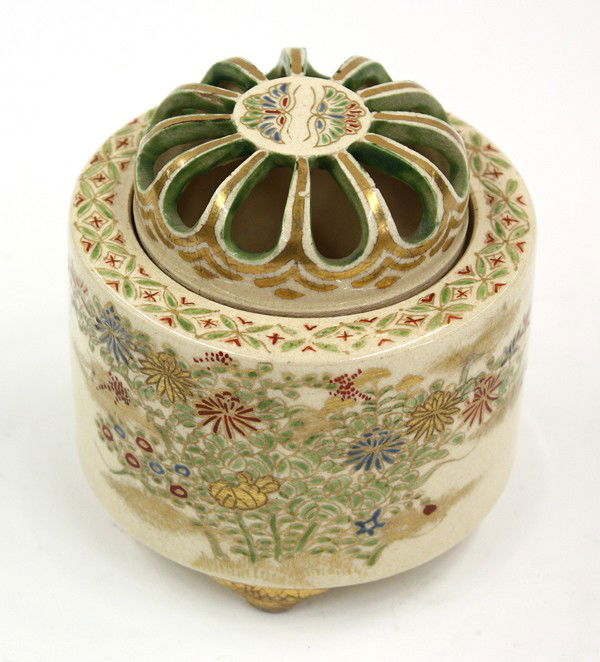 Japanese Satsuma-style Censer: Japanese Satsuma-style small earthenware tripod censer, the cylindrical body with gilt and enamel decoration of various flowering bushes set below the angular shoulder accented with a diaper band, tog