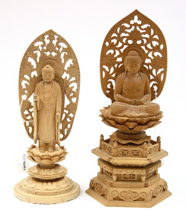 Two Japanese Wood Buddha Figures: (Lot of 2) Japanese carved wood figures of the Buddha, the first seated in meditation with his hands to the front in dhyana (meditation) mudra, the second standing with his hands extended in the renge