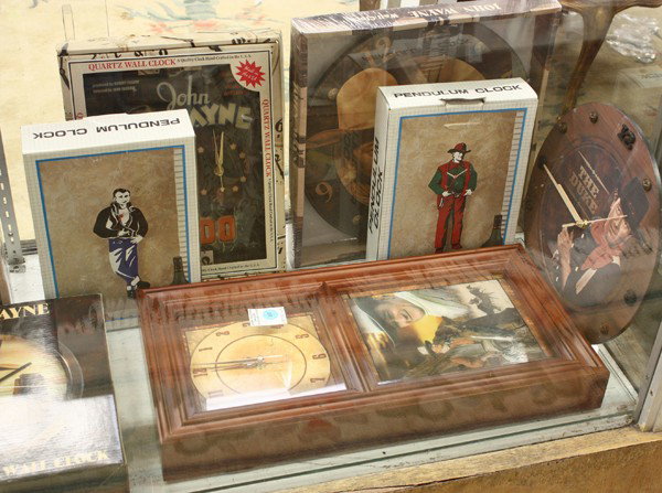 John Wayne memorabilia, clocks: (1 shelf) John Wayne timepieces, including clocks and watches, ''The Duke'', American Legend, Hondo, largest: 20''