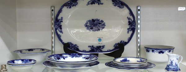 Flow blue porcelain: (lot of 14) Flow blue china including a platter, five bowls (various sizes), waste bowl, four plates, two saucers and an associated creamer, largest 16'' x 11''