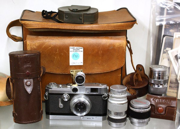 Canon range finder outfit: (lot of 8) Canon range finder model VT, lenses include 35mm F3.2, two 135mm F4, extension tube, 50mm F1.8, 35mm F3.5, two hot-shoe mount view finders, and a leather camera bag
