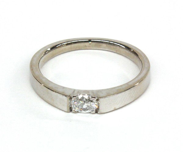 Diamond solitaire white gold ring: Solitaire diamond ring; of 18k white gold, having an oval cut diamond weighing 0.23 ct. Ring size 6.5. There is no buyer's premium on this lot.