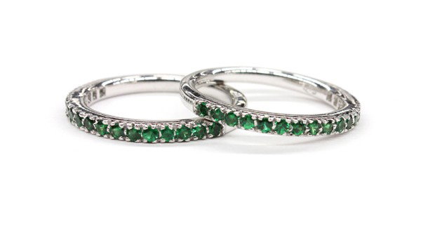 Tsavorite white gold band ring: Two tsavorite band rings; both mounted in 18k white gold, set with a total of (34) tsavorites weighing in total 0.80 ct. Rings size 6.5. There is no buyer's premium on this lot.
