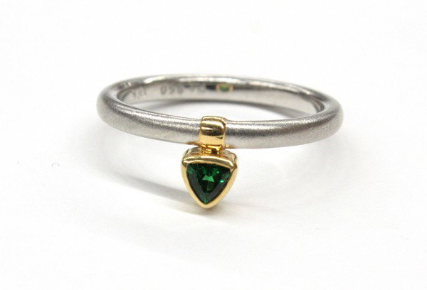 Tsavorite yellow gold platinum ring: Tsavorite ring: mounted in platinum and 18k yellow gold, set with (1) trillion cut tsavorite. Total ring weight 4.9 gram. Ring size 6.75. There is no buyer's premium on this lot.