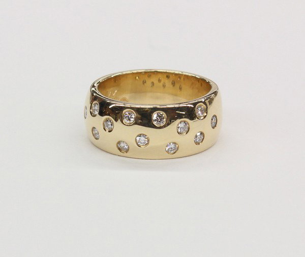 Diamond yellow gold ring: Diamond band ring; mounted in 14k yellow gold, set with (14) flush set diamond accents weighing 0.42 cts, total ring weight 11.1 grams, ring size 6.75. There is no buyer's premium on this lot.