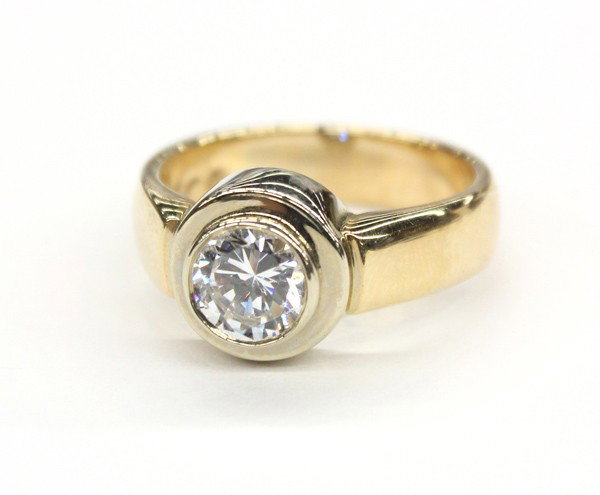 Solitaire CZ white yellow gold ring: Solitaire CZ ring; of 14k yellow and white gold. Total ring weight 7.5 grams. Ring size 6. There is no buyer's premium on this lot.