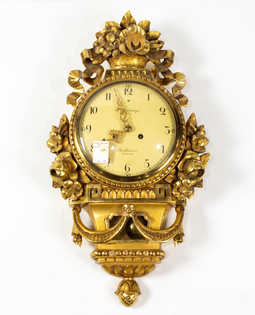 Swedish Neoclassical style giltwood cartel clock: Swedish Neoclassical style giltwood cartel clock, 20th century, the Roman numeral dial inscribed 'F.W. Tornberg, Stockholm, etab. 1869', time and strike movement housed within a floral decorated case,
