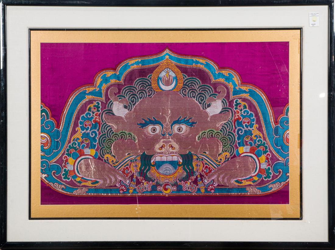 Tibetan woven silk panel: Tibetan woven silk panel, depicting a horned figure against a purple ground, framed and glazed, 21"h. x 32.75"w.