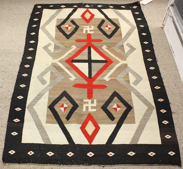 Navajo blankets: (Lot of 2) Navajo blankets, one having a zig zag border with an alternating green and red field, 45''l x 26''w, one having a diamond pattern border surrounding the geometric field with whirling log re