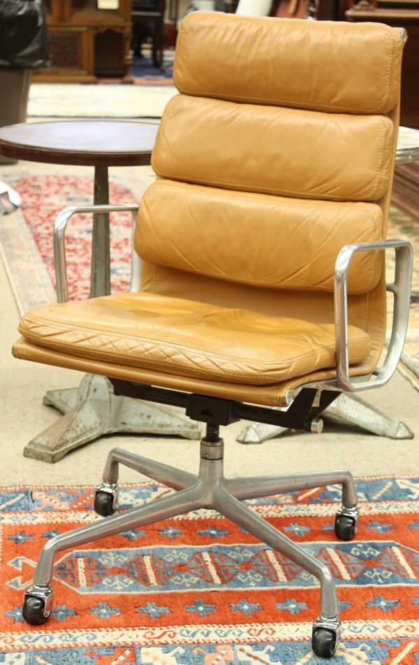 Charles Eames Soft Pad chair, by Herman Miller: Charles Eames Soft Pad chair, by Herman Miller, the aluminum swivel frame wrapped with tan leather upholstery and rising on casters, 39''h x 23''w