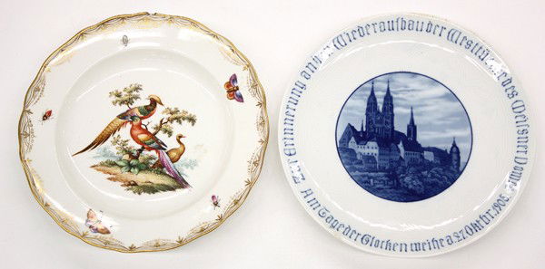 Meissen plates: (Lot of 2) Meissen plates, one plate depicting a cathedral and having an underglaze cross sword mark with cancellations, together with a polychrome decorated plate depicting birds and insects, (chips)