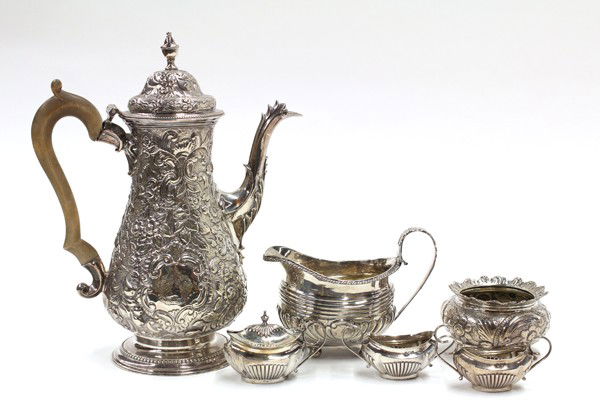 English sterling table accessories: Six English sterling silver associated table accessories consisting of a floral repousse decorated hot beverage pot, by William Gould, London, 1777; cream pitcher on bun feet, London, 1818; Renaissanc
