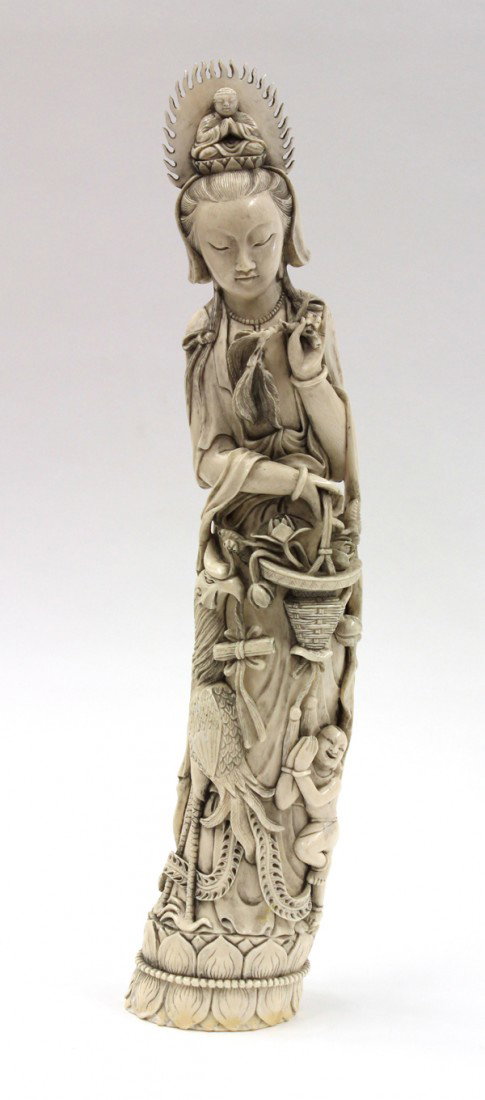 Chinese Large Ivory Guanyin: Chinese large ivory figural carving of Guanyin, fashioned with the bodhisattva of compassion supporting the Amitabha Buddha on the coiffures above the prominent face and with two strands of hair drapi
