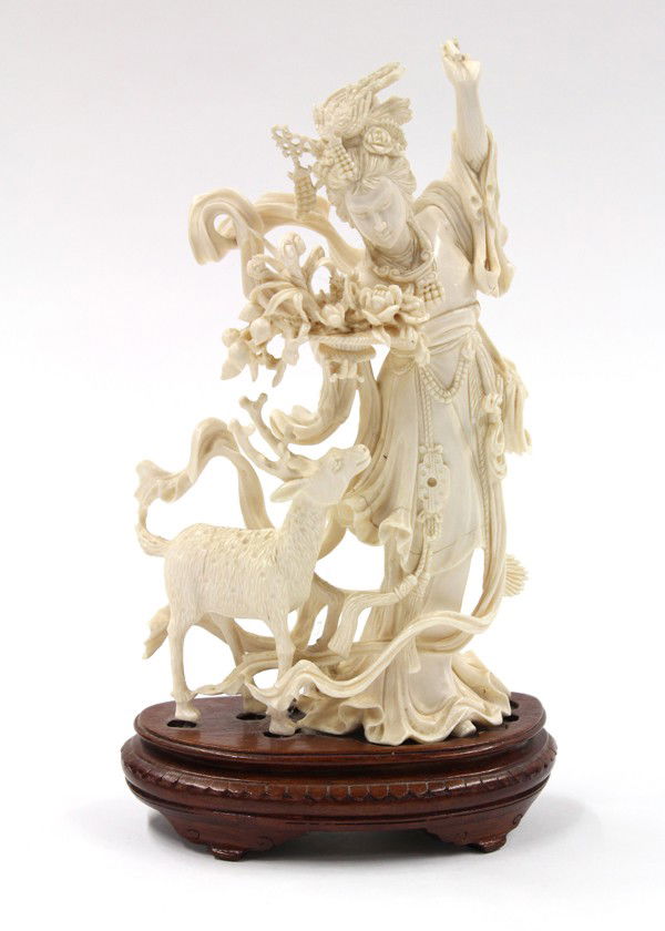 Chinese Ivory Figural Carving, Magu: Chinese figural ivory carving of Magu, the celestial maiden with ornate coiffure decorated with phoenix headdress and adorned in tiers of fluttering robes and scarves, additionally sculpted holding a