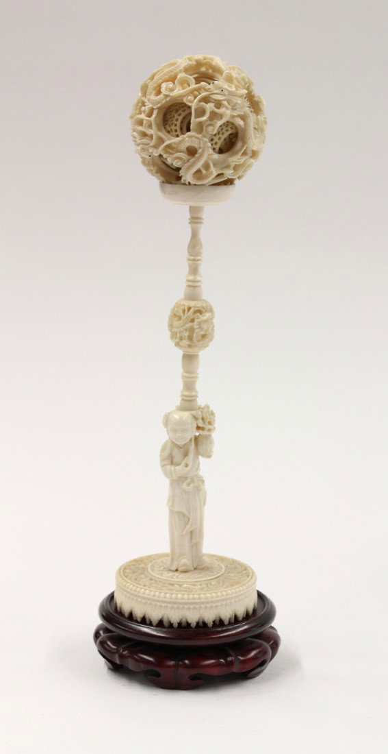 Chinese Ivory Puzzle Ball w/Stand: Chinese ivory puzzle ball with stand, Republic period, comprised of at least seven concentric openwork balls with the outermost carved and undercut with writhing dragons amid stylized clouds, all rest