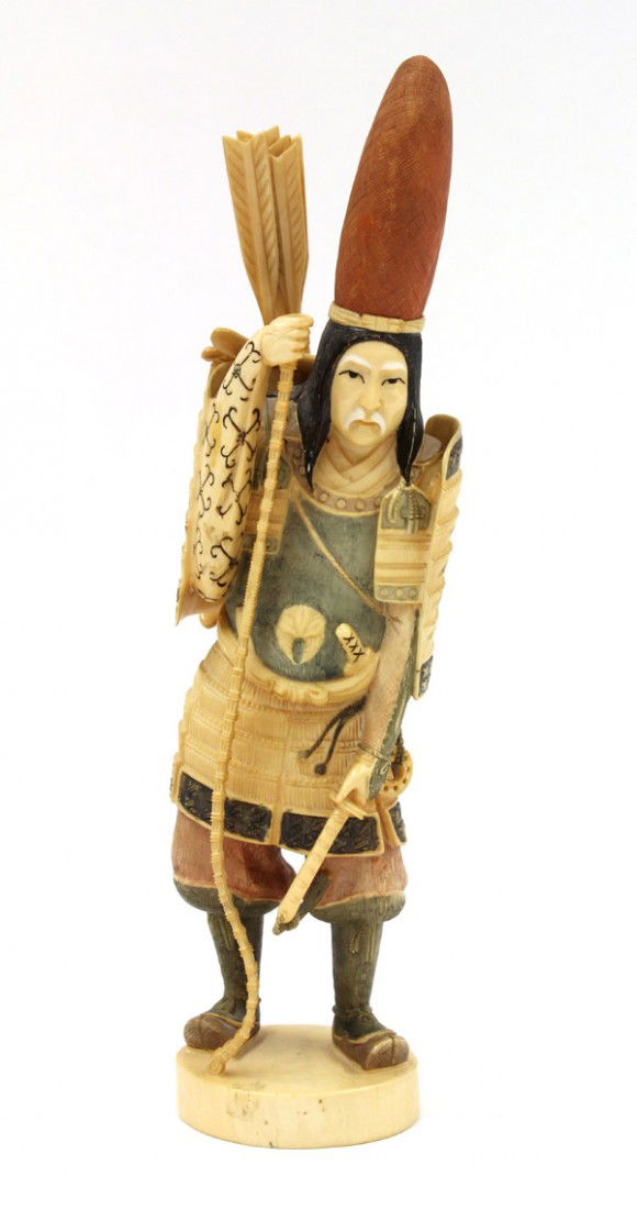 Japanese-style Polychrome Ivory Figure: Japanese-style pigment decorated ivory figural carving, featuring Nasu no Yoichi in military garb wearing a red court hat holding a long bow and carrying a case of arrows on his back, base marked 'Gyo