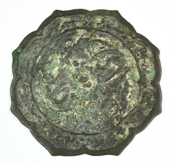 Korean Antique Bronze Mirror: Korean foliate-edged patinated bronze mirror, probably Goryeo dynasty, the back cast with birds amid vegetation and encircled by a scallop-edged band bordered by further foliate decoration (corrosion)