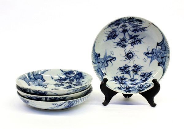 Chinese Blue-and-White Porcelain Dishes: (Lot of 4) Chinese underglaze blue decorated porcelain dishes, each similarly decorated with a flaming jewel to the center bracketed by a pair of stylized phoenixes adjacent to a pair of flowering tre