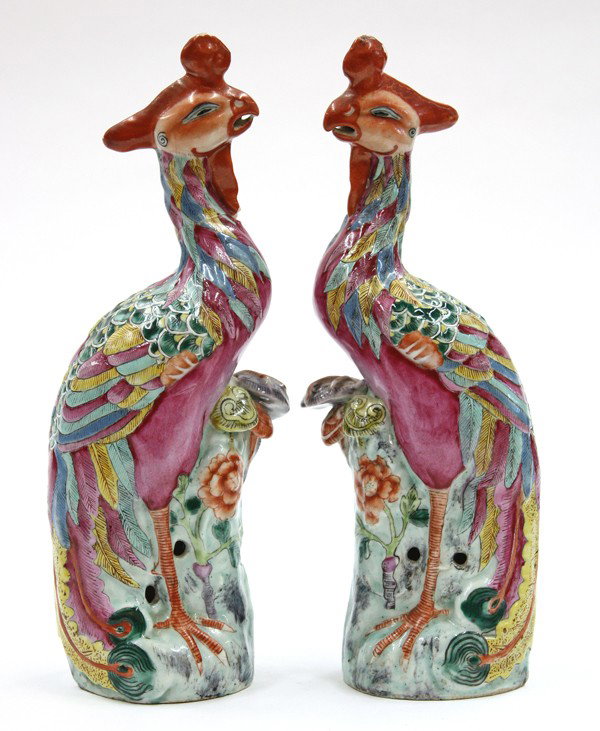 Chinese Polycrhome Porcelain Phoenix: Pair of Chinese polychrome decorated porcelain phoenixes, each with an almond form head surmounted with a shaped red plume with its body covered in feathers of pink, yellow, blue, and green hues, mode