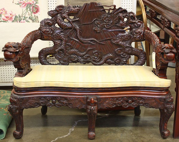 Japanese Export Settee, Meiji: Japanese wooden export settee, Meiji period, the back splat elaborately carved with a dragon encircling Mount Fuji, further fitted to dragon form arms set to the seat with key-fret accents along the e