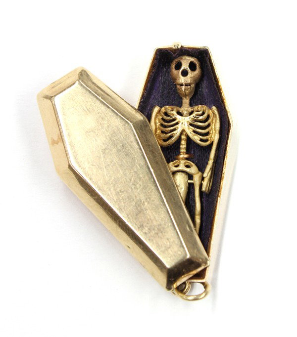 Yellow gold erotica skeleton pendant: 14K yellow gold erotica pendant; featuring a coffin with side-slip cover opening to reveal a skeleton. Total weight 9.3 grams