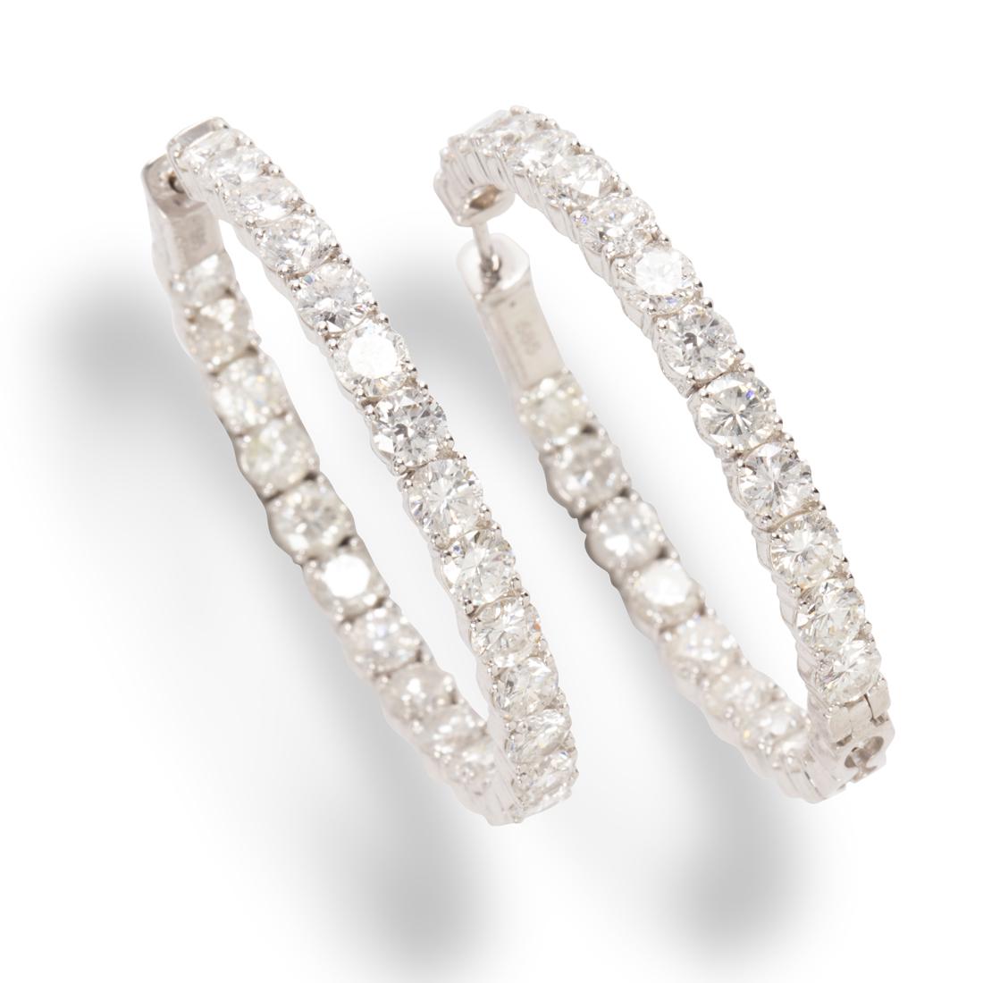 A pair of diamond and fourteen karat white gold hoop earrings (1 of 1)