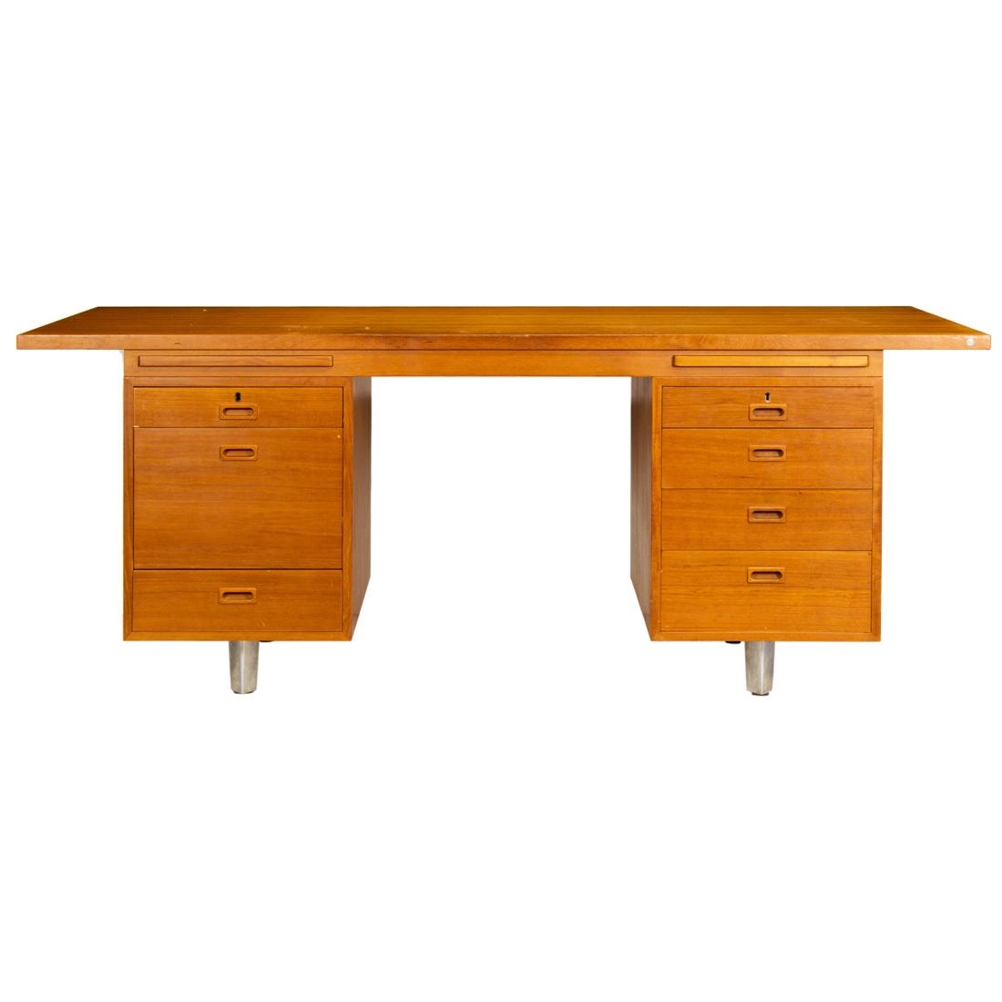 A Nipu Danish teak desk: A Nipu Danish teak desk, having a rectangular top, above the seven drawer case, and rising on chrome legs, 29"h x 75.5"w x 37.5"d