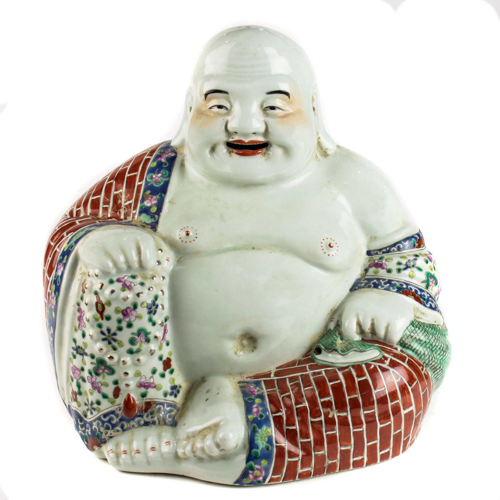 Chinese famille rose figure of Budai: Chinese famille rose figure of Budai, shown seated with his right knee raised, wearing a loose robe opening to reveal his feet and full belly, his face with a laughing expression, his right hand holdi