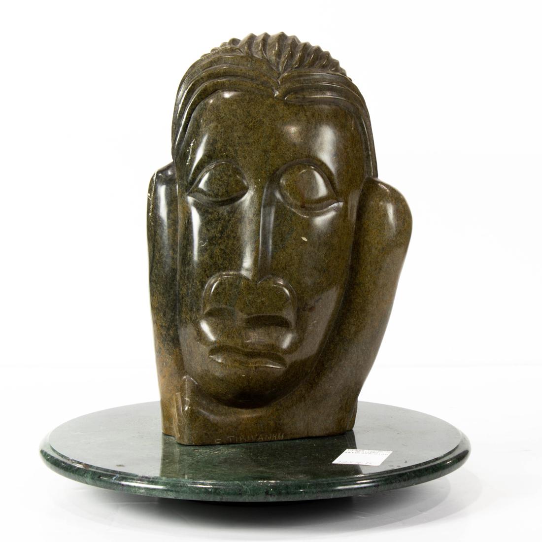 Felix Tirivanno "Young Man Transforming" stone carving 11"h x 8"w x 2"d: Felix Tirivanno "Young Man Transforming" stone carving 11"h x 8"w x 2"d. on hardstone lazy susan 11"d