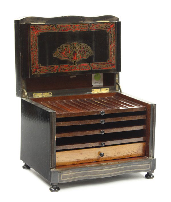 French boulle inlaid box: French boulle style inlaid cigar box circa 1860, the ebonized case with boulle reserves opening to a fitted interior having four slotted cigar trays, and rising on compressed ball feet, 8.5''h x 10.5'