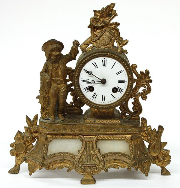 French gilt metal mantle clock: French gilt metal figural mantle clock, the enamel dial having Roman numerals fronting the French movement housed in a case decorated with a fishing boy rising on a footed base having inset alabaster