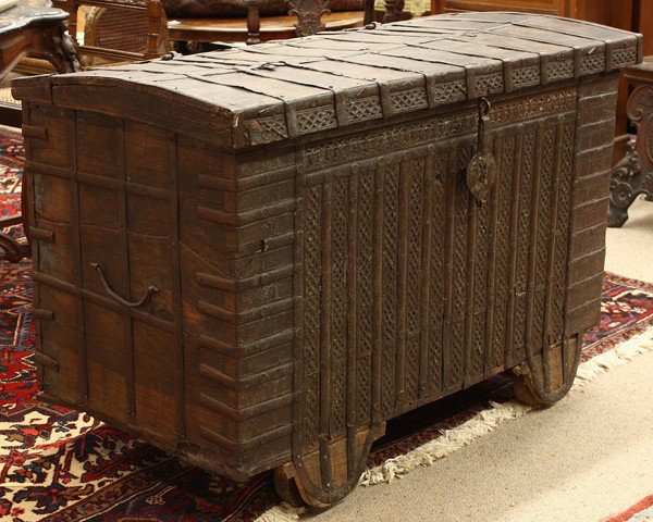 East Indian dowry chest: Anglo-Indian 19th century inlaid and wrought iron dowry chest, having hand-wrought strap hinges supporting the top above the case having repousse decorated metal accents centering the wrought banding,
