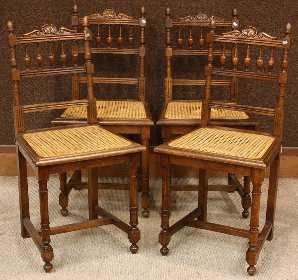 Edwardian side chairs: (lot of 4) Henri II style oak side chairs circa 1890, having caned seats and rising on turned legs conjoined with an H stretcher, 35''h