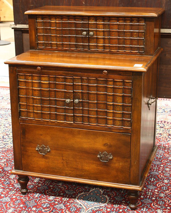 Federal style mahogany desk: Federal style mahogany desk, the carved book form doors centering the slide out writing surface having embossed leather, and rising on turned legs, 34''h x 25''w x 19''d