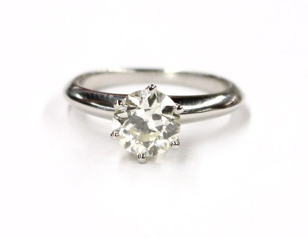 Solitaire diamond TIFFANY & CO platinum band ring: TIFFANY & CO platinum band ring with a round cut diamond weighing 1.04 cts. Total ring weight 4.1 grams. Ring size 3.75