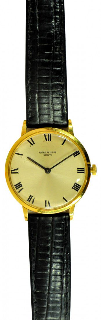 Gentleman's Patek Philippe wrist watch: Gentleman's PATEK PHILIPPE wrist watch; of 18k yellow gold, having a circular silver dial face, with black Roman chapters and blackened hands (signs of wear), the watch is set within a 33mm, plain bez