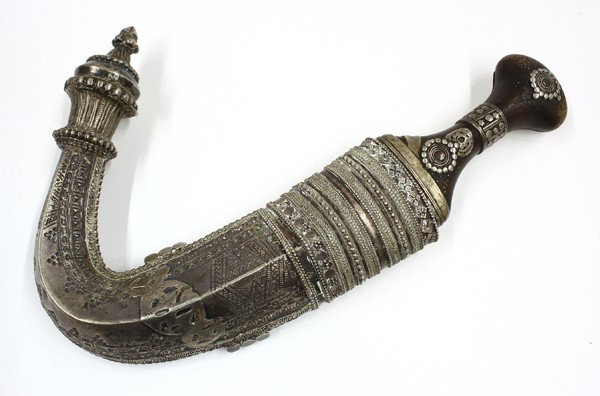 Arabian Jambiya (Knife) w/Horn Hilt: Arabian jambiya (knife) with a silver scabbard and horn hilt, the curved double-edged blade with a center rib and issuing from a dark horn hilt with a wide pommel and embellished with silver fittings 