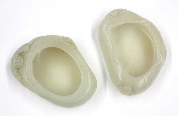 Chinese Hardstone Brush Wahers, Lotus Leaf: (Lot of 2) Chinese hardstone/jade brush washers, each similarly fashioned as a cupped lotus leaf, the first with chanchu and a chain of linked coins to the sides, the second with Liu Hai holding a cha