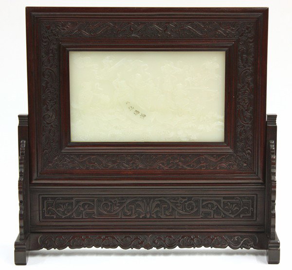 Chinese Table Screen w/Jade Figural Plaque: Chinese dark stained hardwood table screen with a jade plaque, the pale green plaque carved in relief with the Eight Immortals crossing the the sea (ba xian guo hai), the reverse with a hardwood plaqu