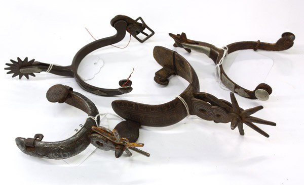 Western spurs: (lot of 31) Associated Western single spurs of mostly wrought iron, some with silver overlay and conchos, one signed Don Ricardo, various styles including California, Charro, Wyoming, and Mexico