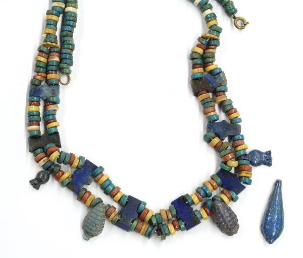 Egyptian mummy faience bead necklaec: Ancient Egyptian, multi-colored Mummy faience bead, two strand necklace; separated by 8 cartouche plaques of lapis lazuli with a fringe of pomegranate and coin (center petal drop broken off). Accompan