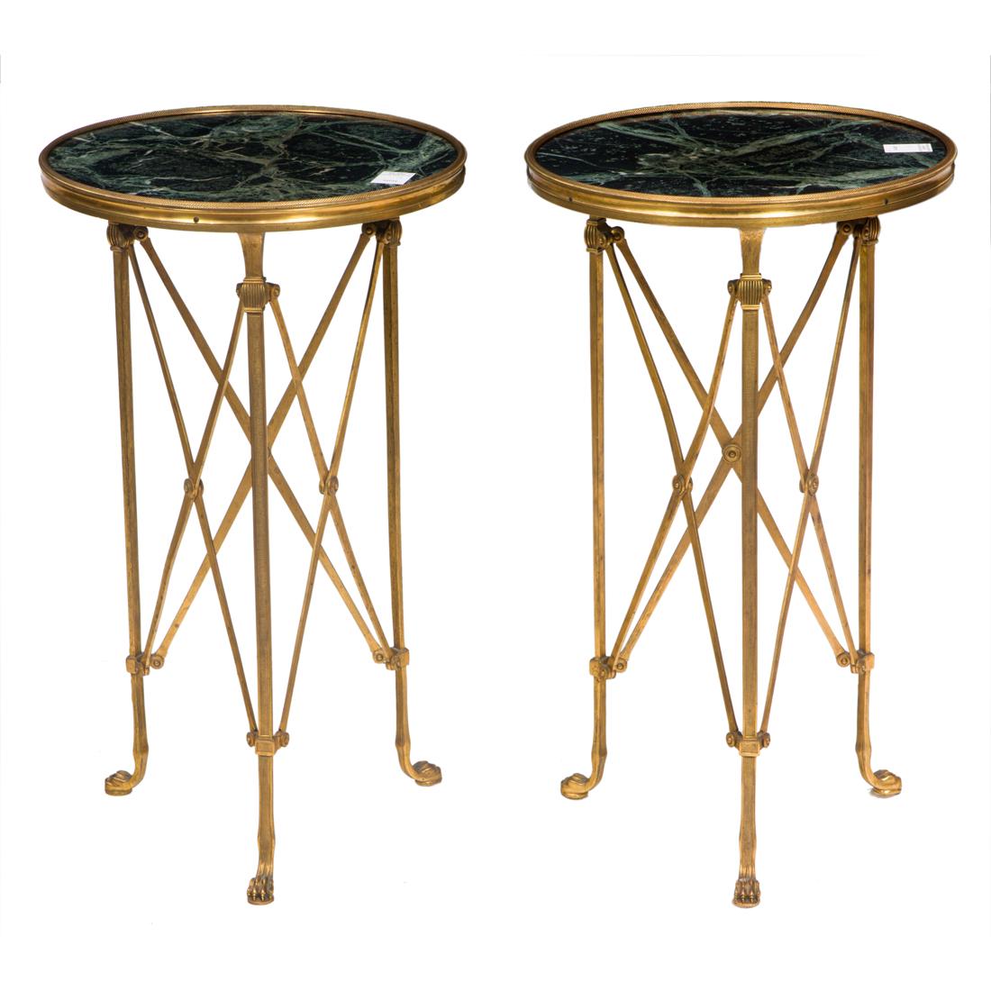 A pair of French Empire style gueridons: A pair of French Empire style gueridons, each having an inset marble top above a gilt tripartite base, with x-form supports, 27.5"h x 16"dia.
