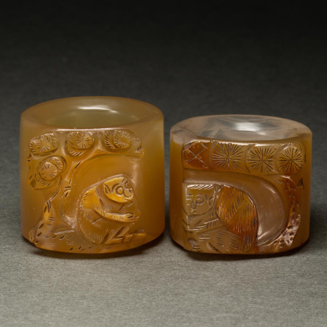 Pair of Chinese agate 'monkey and pine' archer's rings (1 of 2)