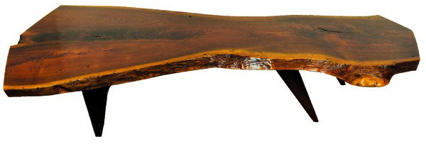 George Nakashima live edge slab coffee table: George Nakashima live edge slab coffee table, the free edge top executed in highly figured walnut and rising on rectangular and tapered legs, retains original finish, and was commissioned by the consi