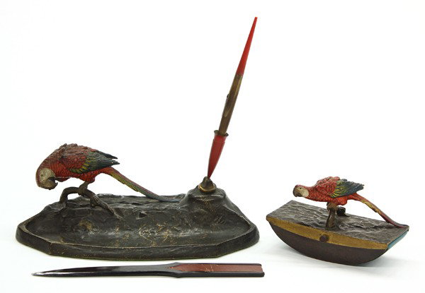 Waterman's fountain pen desk set: (lot of 4)Waterman's fountain pen desk set circa 1900, consisting of a master pen tray with pen, having an Austrian cold painted bronze parrot, 3.5''H. 9.5''W. 4.5''D, the blotter having a parrot hand