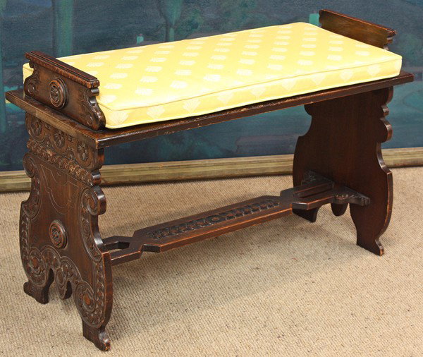Continental carved window bench: Continental carved window bench circa 1890, having carved rosette detail flanking the stretcher, and rising on shield form legs, 23''h x 35''w x 14''d