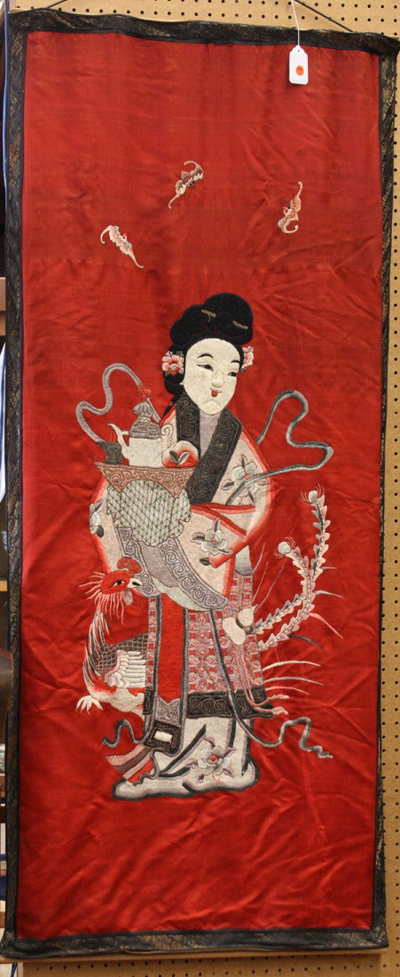 Chinese Embroidered Panel, Magu: Chinese embroidered hanging red silk panel, featuring the female immortal Magu carrying a tray of wine and fruit accompanied by a phoenix, all set below three red bats executed in satin stitches on a 