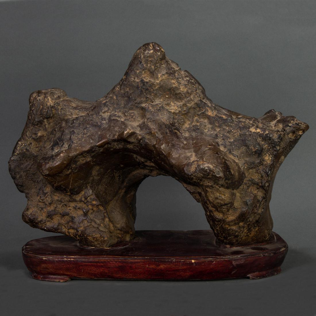 Chinese black Lingbi limestone scholar's rock: Chinese black Lingbi limestone scholar's rock, of arching form displaying a peak, Northern style wood stand, width17".