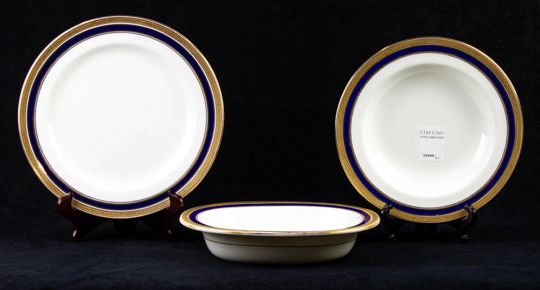 (Lot of 23) Cauldon porcelain plates and soup bowls with gilt tooled and cobalt banded rims: (Lot of 23) Cauldon porcelain plates and soup bowls with gilt tooled and cobalt banded rims, comprising (13) dinner plates, (11) two-handled soup plates retailed by Wells, Burrage Co. Boston plates an