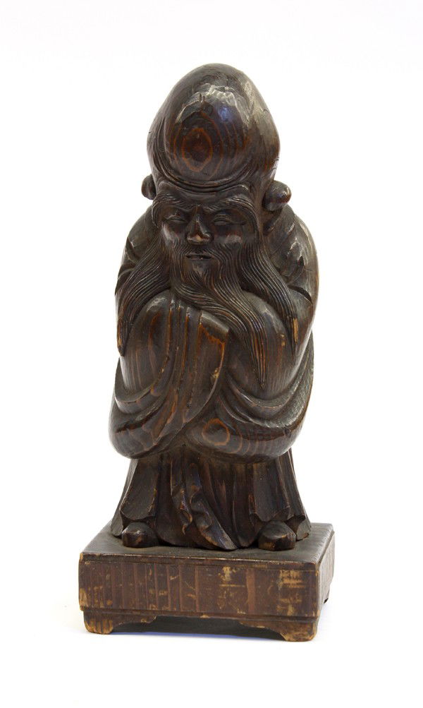 Japanese Wood Fukurokuju Figure: Japanese stained paulownia wood figural carving of Fukurokuju, standing with his hands to the front and hidden by his long robes, the bearded face with crisply carved features, the square plinth signe
